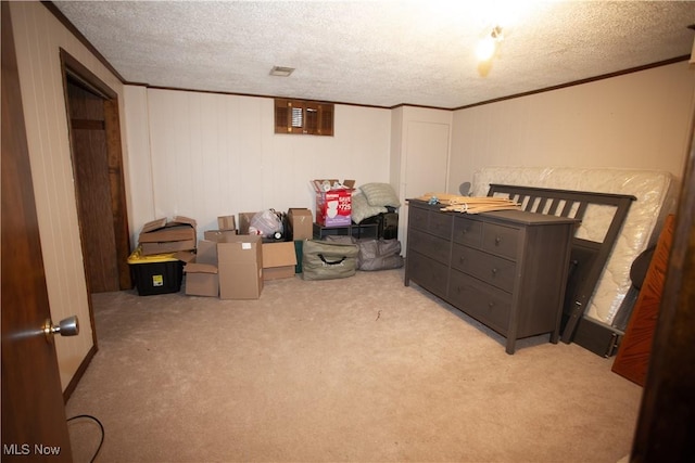 bedroom featuring carpet flooring, a textured ceiling, and ornamental molding