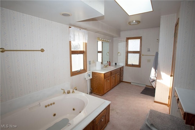 full bathroom with wallpapered walls, vanity, a tub with jets, and a baseboard radiator