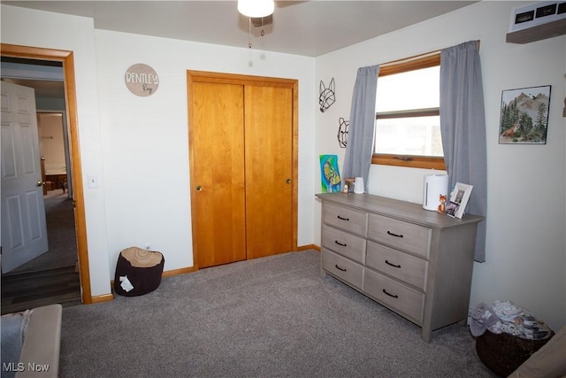 bedroom with carpet flooring, baseboards, and a closet