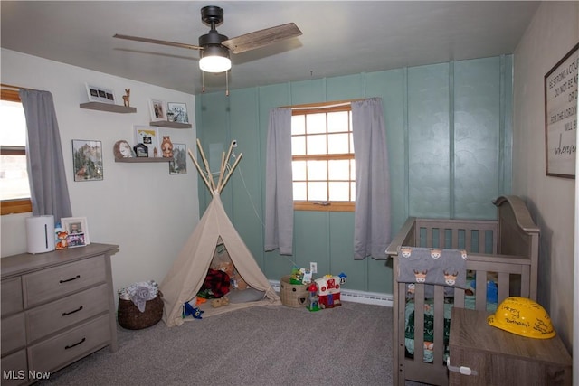 carpeted bedroom with a baseboard heating unit