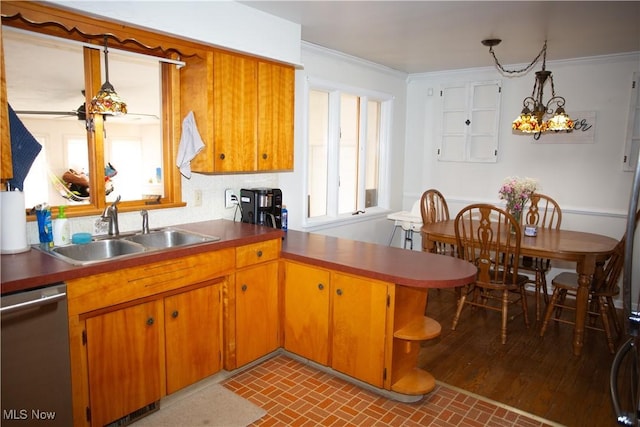 kitchen with ornamental molding, dishwasher, brick floor, and a sink