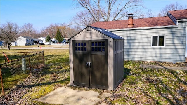 view of shed featuring fence