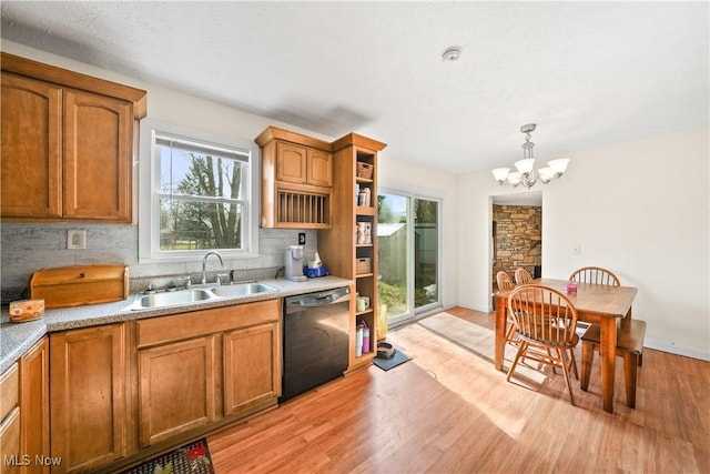 kitchen with black dishwasher, brown cabinets, and a sink