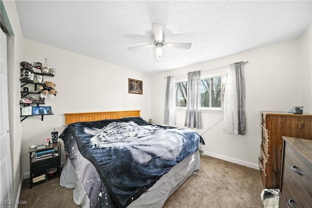 bedroom featuring a ceiling fan, carpet, baseboards, and a textured ceiling