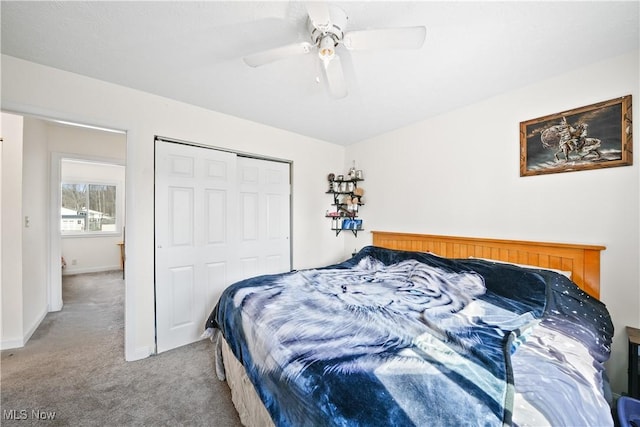 bedroom with carpet flooring, baseboards, a closet, and ceiling fan