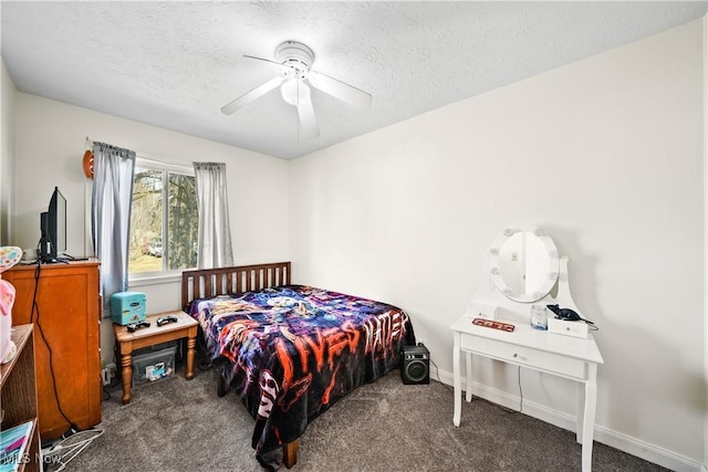 carpeted bedroom featuring baseboards, a textured ceiling, and ceiling fan