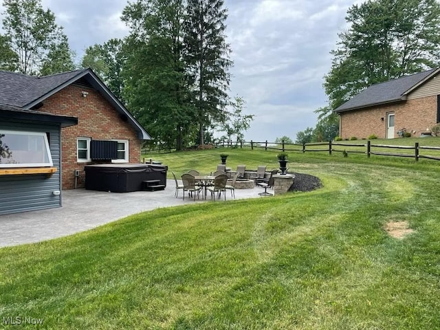 view of yard featuring a patio, fence, and a hot tub