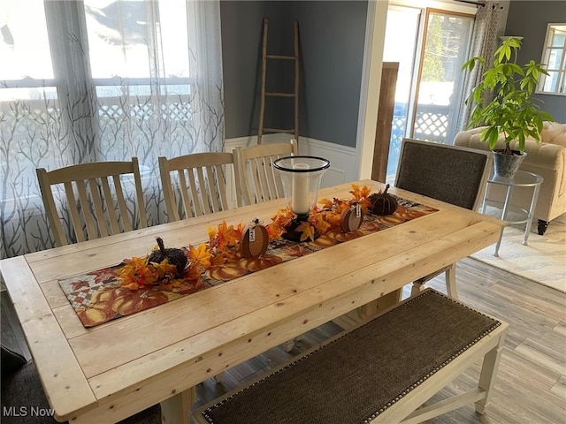 dining space with wood finished floors