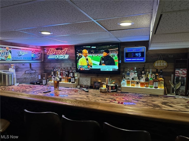 bar featuring a drop ceiling and a dry bar