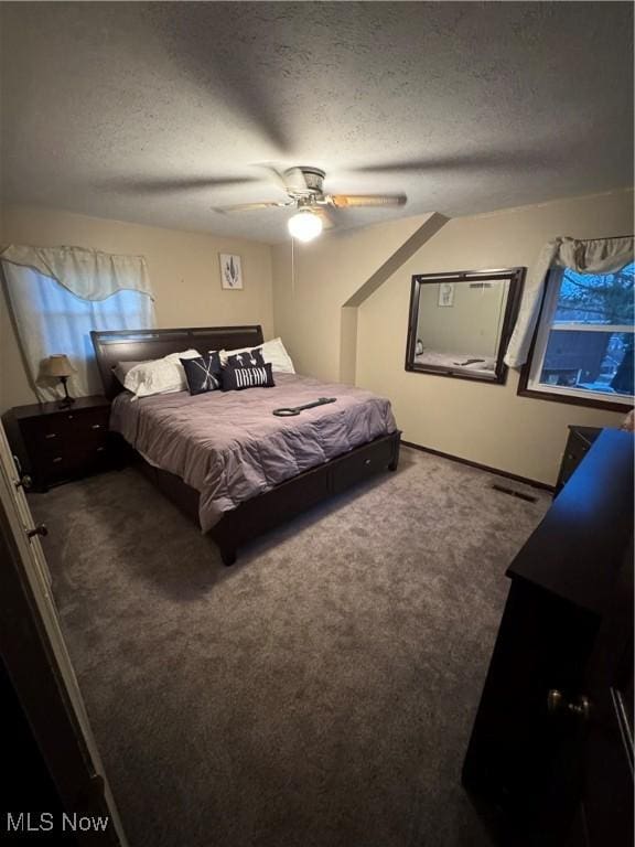 carpeted bedroom featuring visible vents, a textured ceiling, and ceiling fan