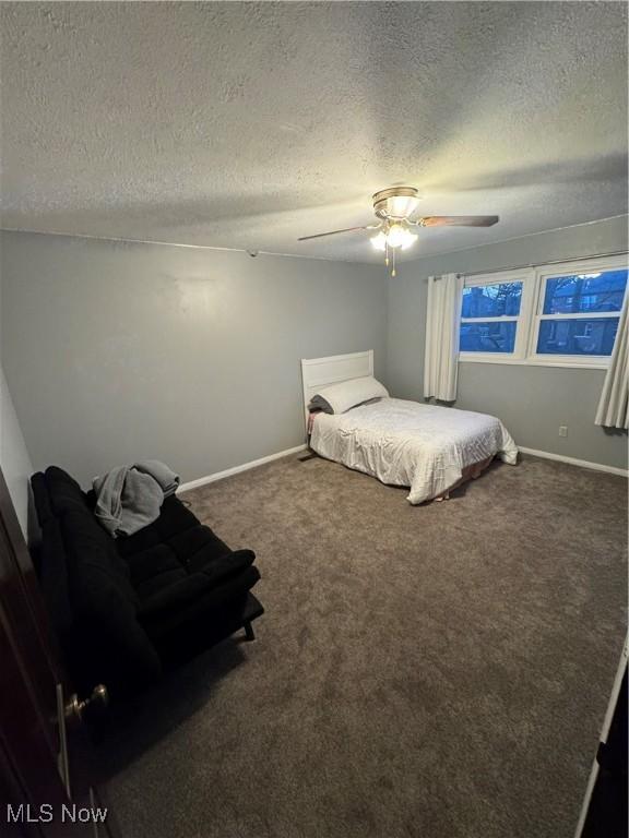 bedroom with carpet flooring, ceiling fan, a textured ceiling, and baseboards