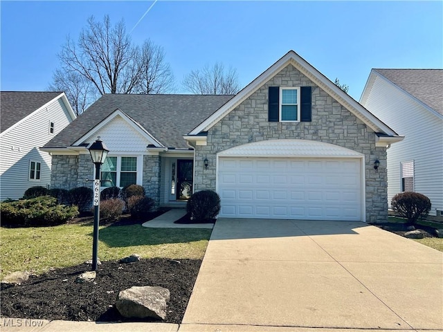 view of front of home with an attached garage, a shingled roof, driveway, and a front yard