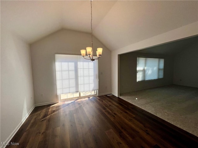 unfurnished room with an inviting chandelier, baseboards, lofted ceiling, and wood finished floors