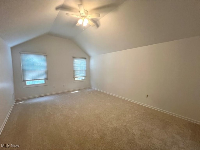 additional living space featuring a ceiling fan, vaulted ceiling, carpet, and baseboards