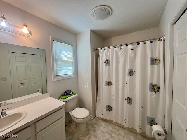 bathroom featuring vanity, toilet, a shower with curtain, and visible vents