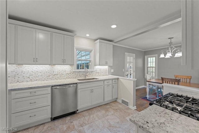 kitchen featuring visible vents, white cabinetry, a sink, stainless steel dishwasher, and backsplash