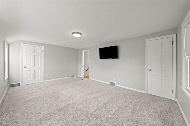 unfurnished bedroom with carpet, visible vents, and baseboards