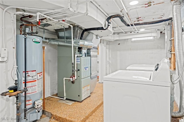 interior space with gas water heater, heating unit, and washing machine and dryer