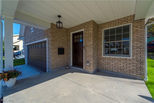 view of patio / terrace with driveway and a garage