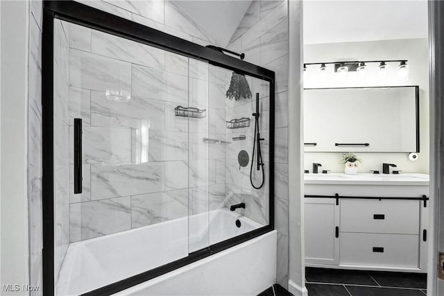 full bath featuring double vanity, tile patterned flooring, a sink, and bath / shower combo with glass door