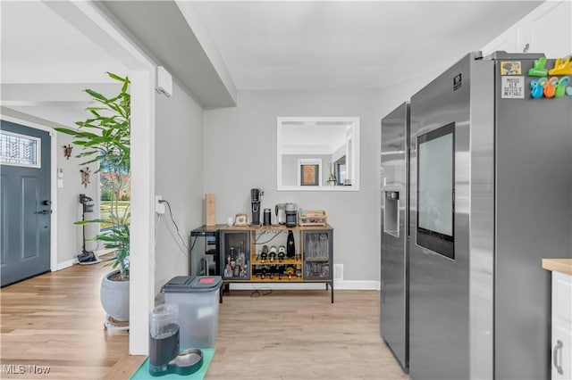 entrance foyer with light wood-type flooring and baseboards