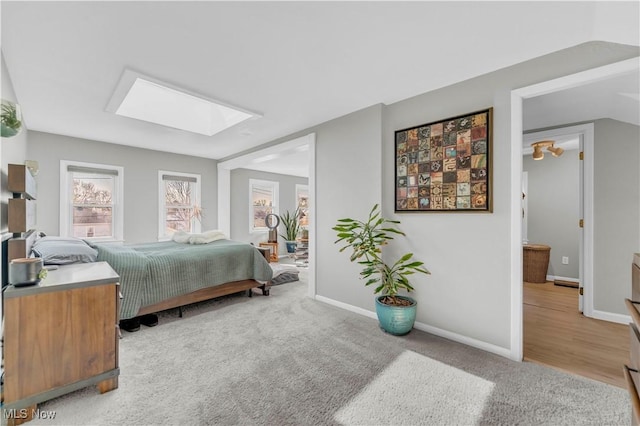 bedroom with baseboards, carpet floors, and a skylight