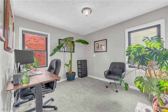 office area featuring baseboards, carpet floors, and a healthy amount of sunlight