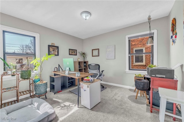 carpeted home office featuring baseboards