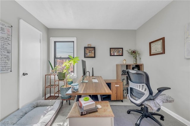 office space featuring light colored carpet and baseboards