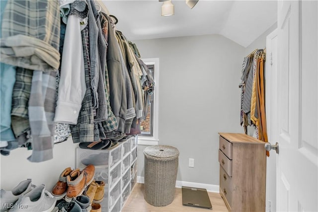 walk in closet featuring lofted ceiling and wood finished floors