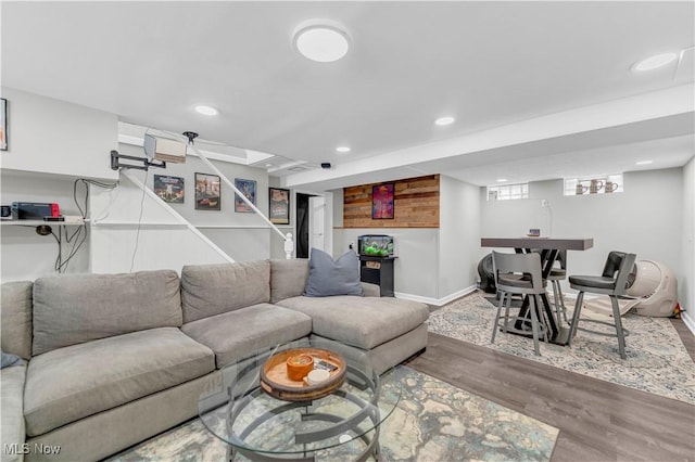 living area with recessed lighting, baseboards, and wood finished floors