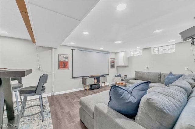 living area featuring recessed lighting, baseboards, and wood finished floors