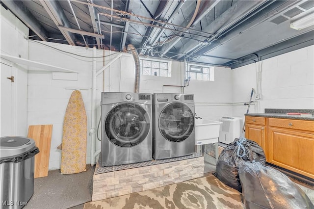 laundry room featuring a sink and separate washer and dryer