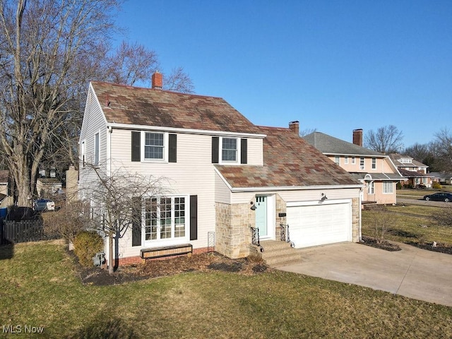 view of front of house with a garage, a front yard, and driveway