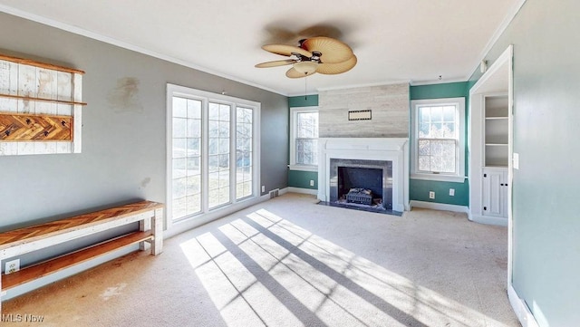 unfurnished living room with carpet, ornamental molding, and a fireplace