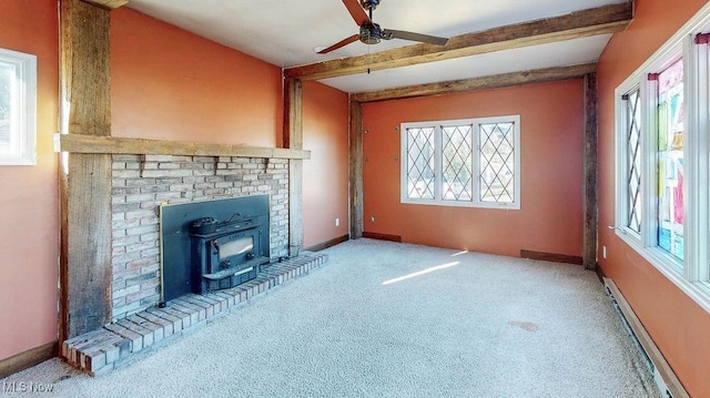 unfurnished living room with a wealth of natural light, beam ceiling, a baseboard heating unit, and baseboards