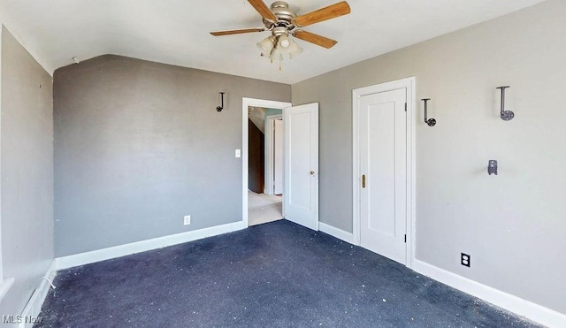 unfurnished bedroom featuring baseboards, lofted ceiling, and a ceiling fan