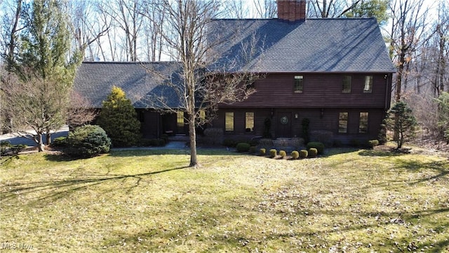 view of front of house featuring a front yard and a chimney