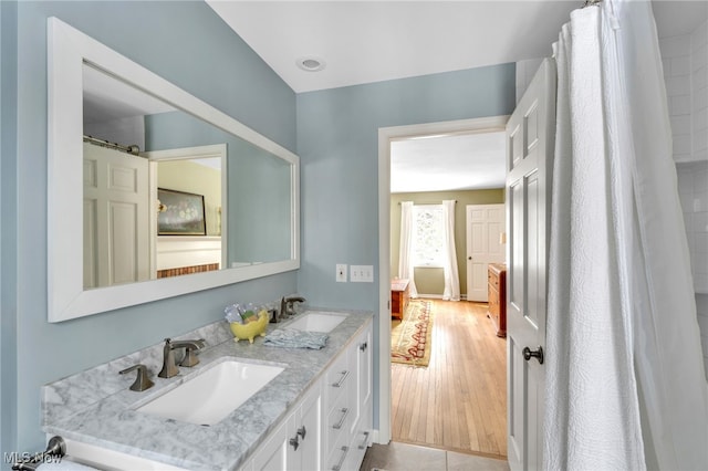 bathroom with a sink and double vanity