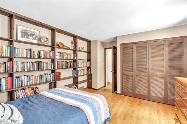 bedroom with light wood-type flooring and a closet