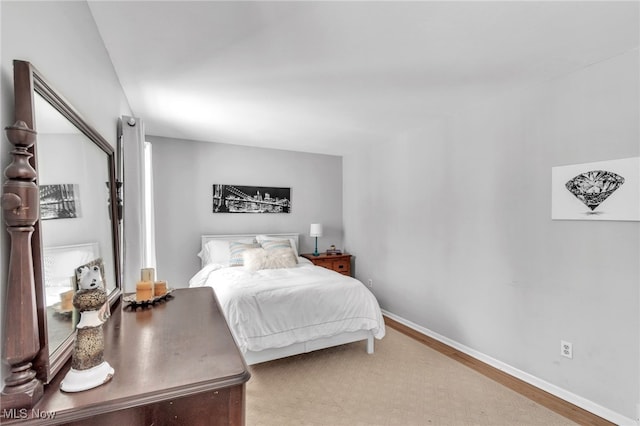 bedroom featuring wood finished floors and baseboards