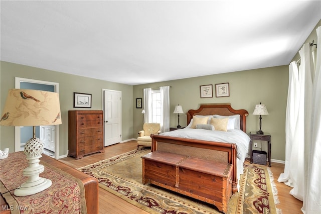 bedroom with wood finished floors and baseboards