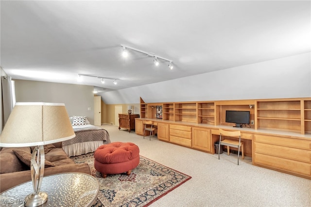 living area featuring lofted ceiling, light colored carpet, and built in study area