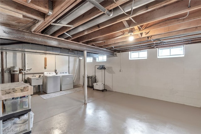 below grade area featuring independent washer and dryer and a sink