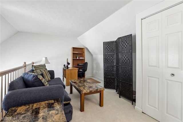 interior space featuring vaulted ceiling, baseboards, and light carpet