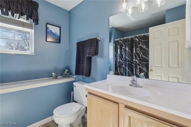 full bathroom with vanity, a shower with shower curtain, and toilet