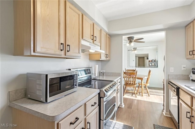 kitchen featuring wood finished floors, light brown cabinetry, stainless steel appliances, light countertops, and under cabinet range hood