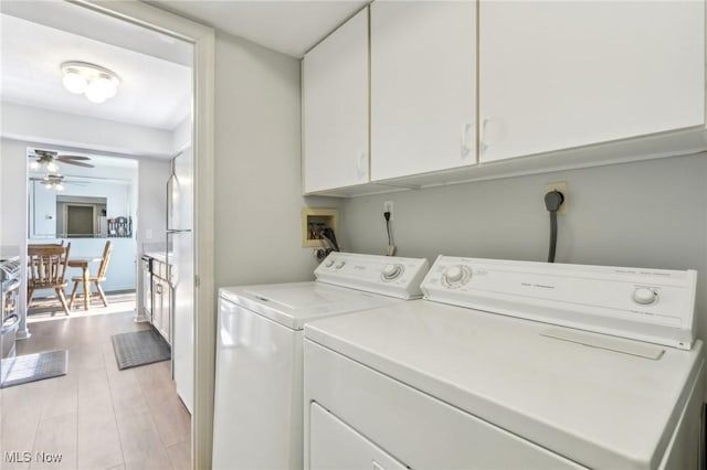 washroom with separate washer and dryer, cabinet space, light wood-type flooring, and ceiling fan