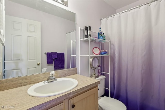 bathroom featuring toilet and vanity