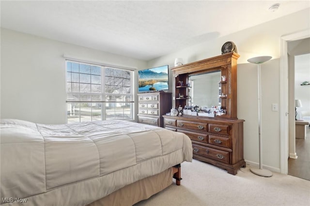 carpeted bedroom with baseboards